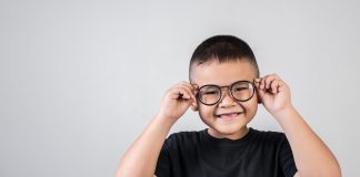 Criança com óculos de grau; casos de miopia aumentam e podem ter relação com uso de telas e permanência em ambientes fechados.