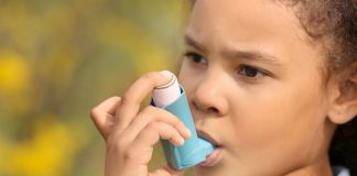 Criança com bombinha de asma ilustra matéria sobre crianças com asma na pandemia.