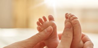 Projeto de lei que amplia o teste do pezinho foi aprovado no Senado; mãos adultas seguram pés de bebê