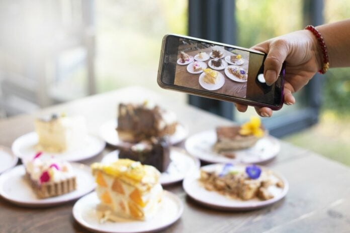 Combate à obesidade infantil: a publicidade chega à sua casa?; imagem mostra tortas em pratos e celular tirando foto das mesmas