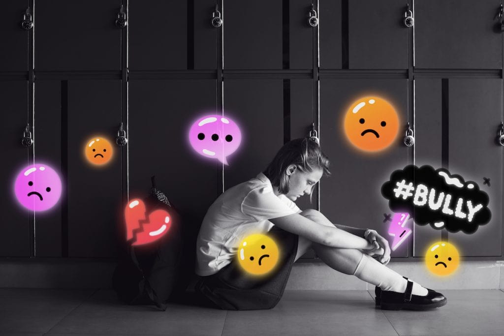 Adolescência e redes sociais; uma combinação explosiva; menina adolescente está sentada no chão com cabeça baixa e há vários emojis e ícones no ar