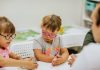 Ministro da Educação diz que as crianças com deficiência “atrapalham”; crianças com síndrome de down usando óculos coloridos sentados em frente a uma mesa brincando