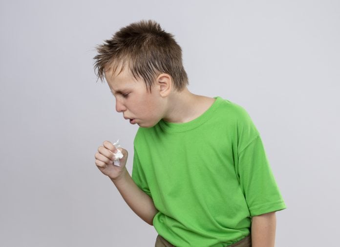 Doenças fora de época: surto de vírus sincicial respiratório afeta crianças; criança com blusa verde tossindo