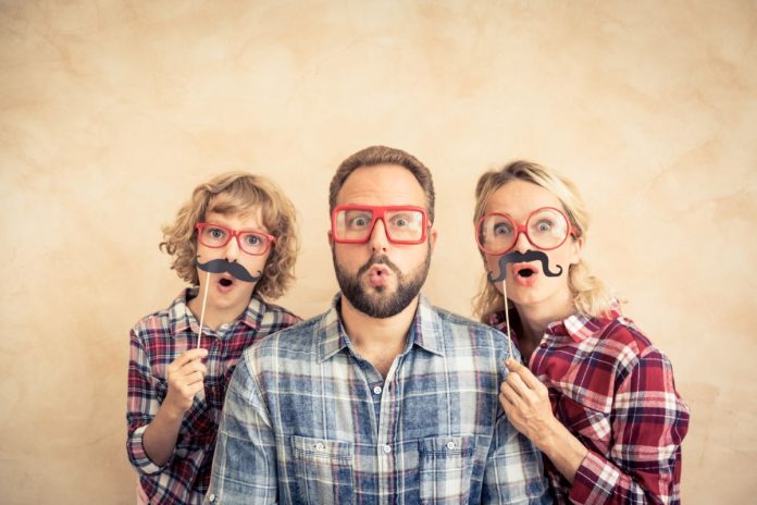 Família com bom humor usa bigodes falsos para brincar