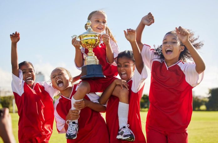 Crianças vibram com taça na mão